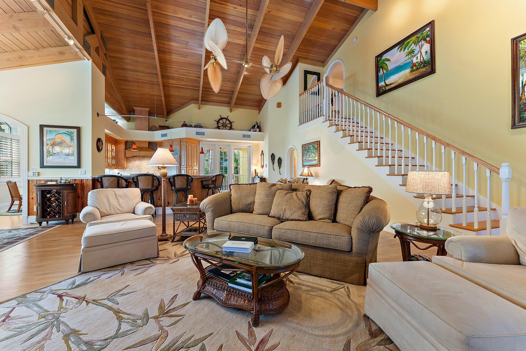 134 North Beach Road Hobe Sound, FL 33455 - Photo 18 of 54 a living room with furniture a ceiling fan and a rug