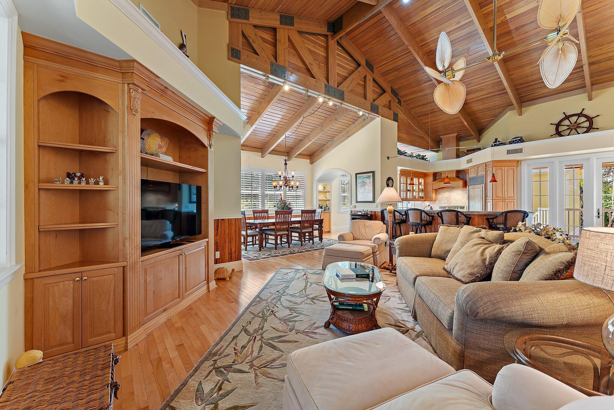 134 North Beach Road Hobe Sound, FL 33455 - Photo 19 of 54 a living room with furniture a flat screen tv and kitchen view