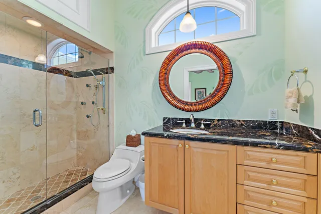 a bathroom with a toilet a sink and a mirror