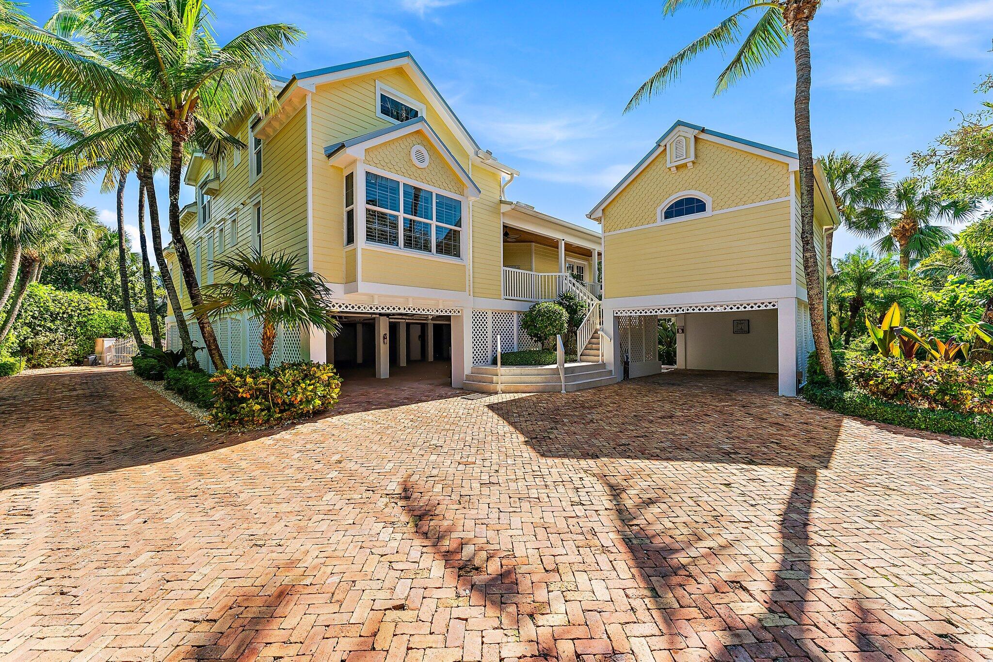 134 North Beach Road Hobe Sound, FL 33455 - Photo 4 of 54 a front view of a house with a yard and garage