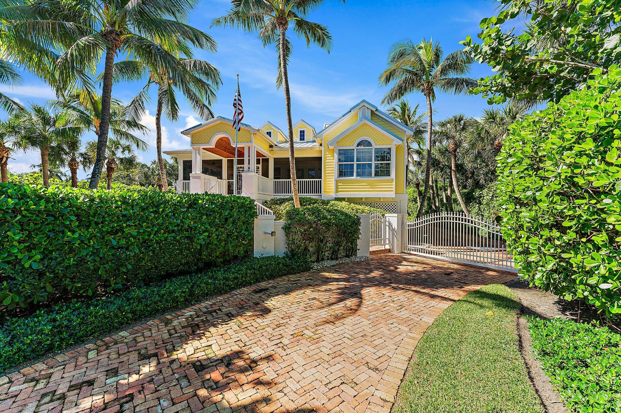 134 North Beach Road Hobe Sound, FL 33455 - Photo 6 of 54 a front view of a house with a yard