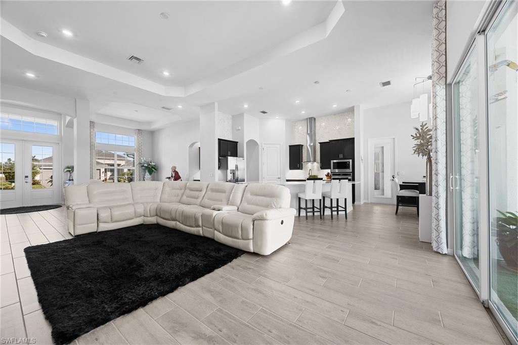 5415 Ternberry Road Ave Maria, FL 34142 - Photo 12 of 45 a living room with furniture and a large window