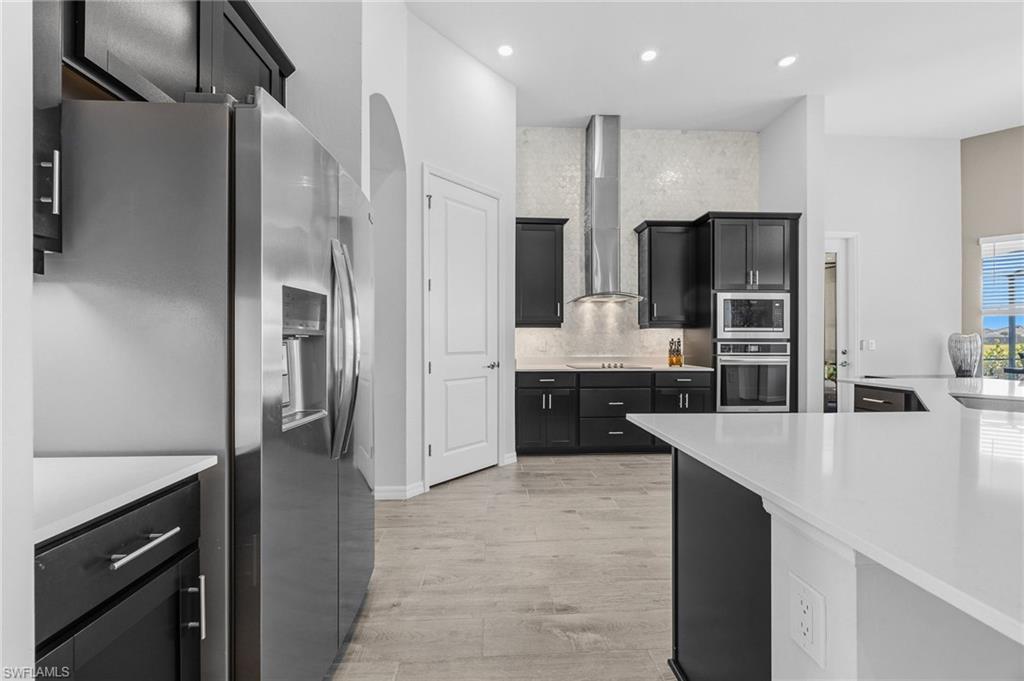 5415 Ternberry Road Ave Maria, FL 34142 - Photo 14 of 45 a large kitchen with stainless steel appliances a refrigerator and a sink