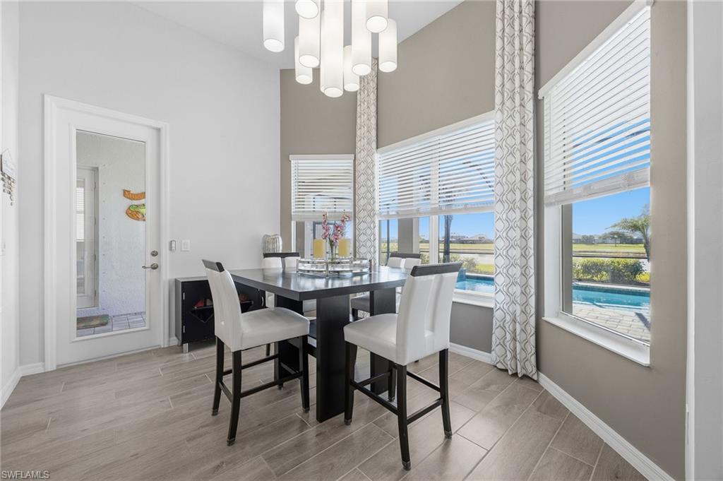5415 Ternberry Road Ave Maria, FL 34142 - Photo 16 of 45 a view of a dining room with furniture window and outside view