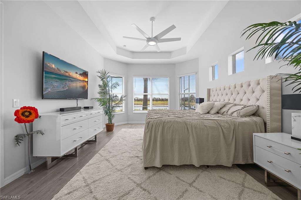 5415 Ternberry Road Ave Maria, FL 34142 - Photo 18 of 45 a spacious bedroom with a bed and a flat screen tv