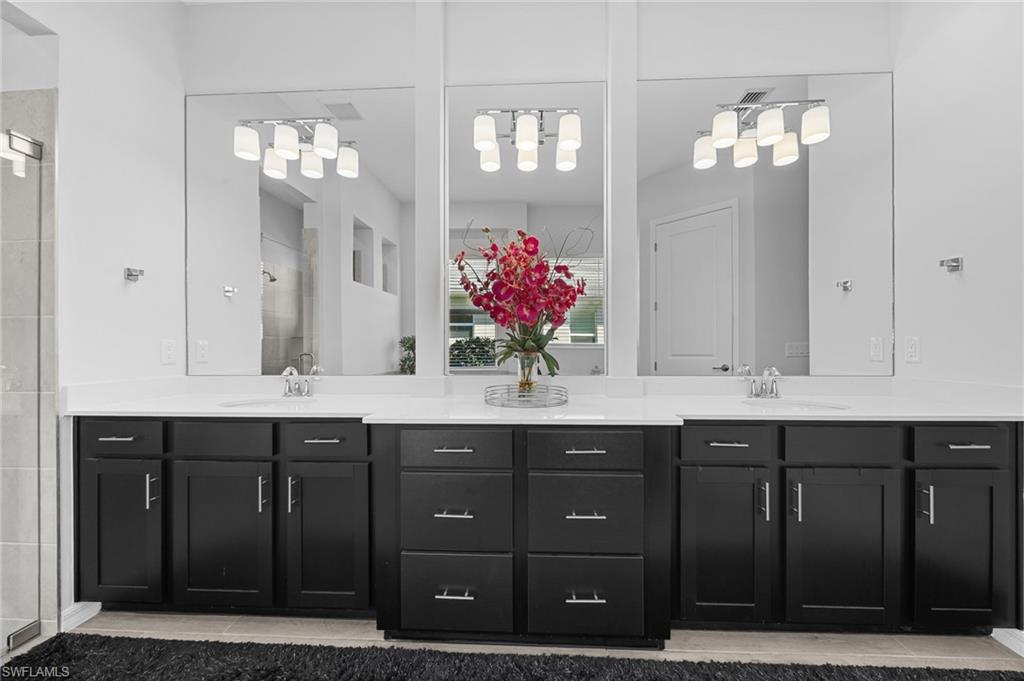 5415 Ternberry Road Ave Maria, FL 34142 - Photo 22 of 45 a bathroom with double vanity sinks a vanity a lamp and a mirror