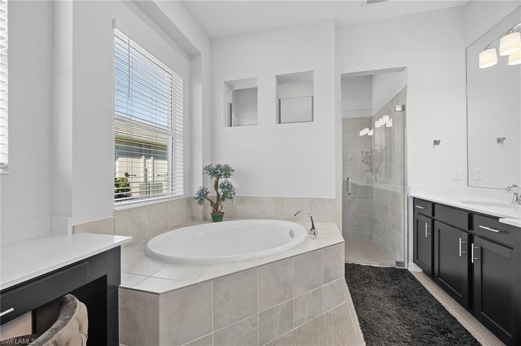 5415 Ternberry Road Ave Maria, FL 34142 - Photo 23 of 45 a bathroom with a sink and a mirror
