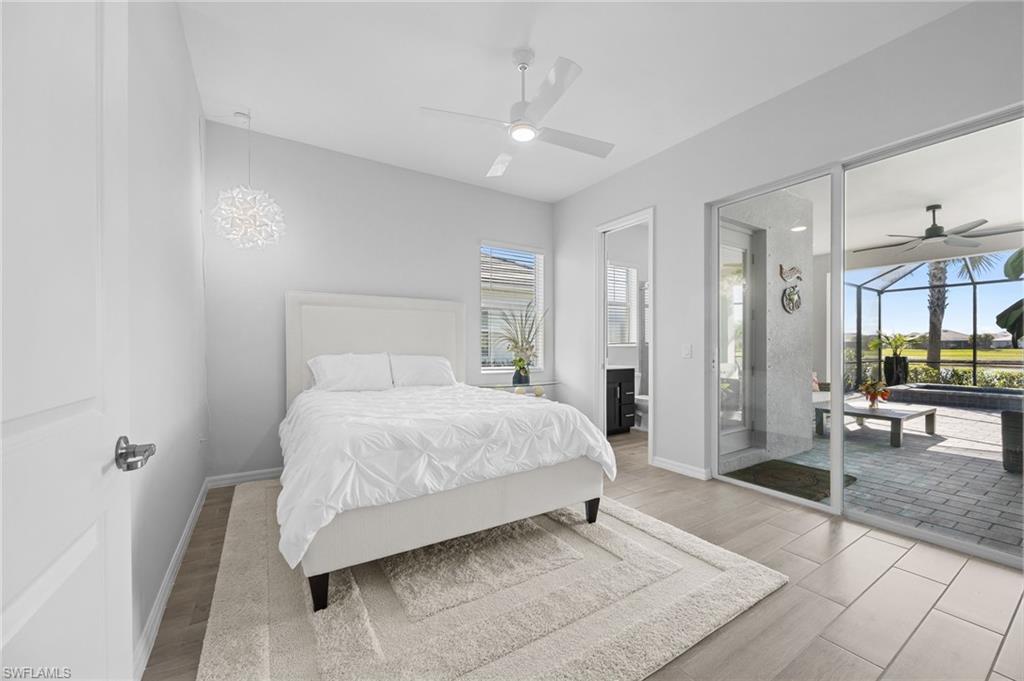 5415 Ternberry Road Ave Maria, FL 34142 - Photo 31 of 45 a spacious bedroom with a bed and a table in it