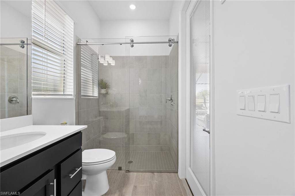 5415 Ternberry Road Ave Maria, FL 34142 - Photo 33 of 45 a bathroom with a sink a toilet and shower