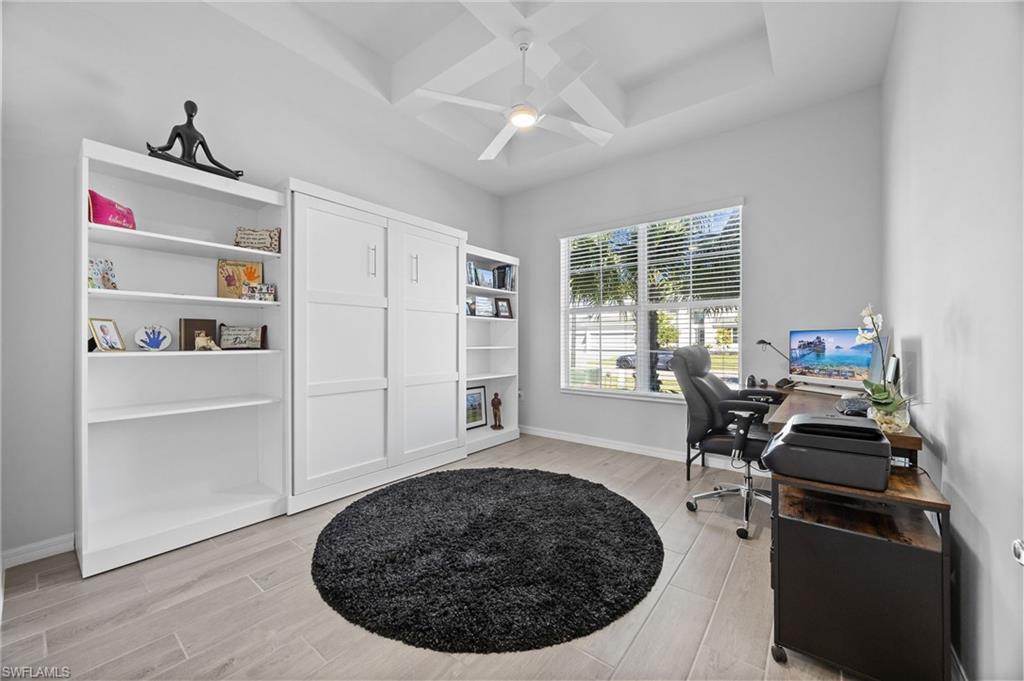 5415 Ternberry Road Ave Maria, FL 34142 - Photo 34 of 45 a living room with furniture a window and gym equipment