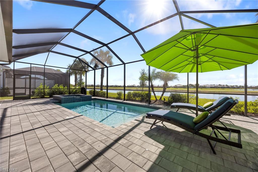 5415 Ternberry Road Ave Maria, FL 34142 - Photo 36 of 45 a view of a swimming pool with a bench in patio