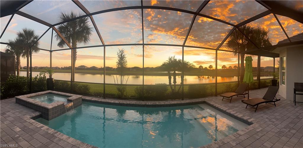 5415 Ternberry Road Ave Maria, FL 34142 - Photo 41 of 45 a living room with a floor to ceiling window and potted plants