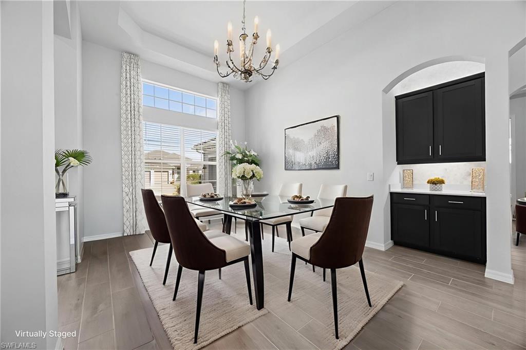 5415 Ternberry Road Ave Maria, FL 34142 - Photo 8 of 45 a view of a dining room with furniture and chandelier