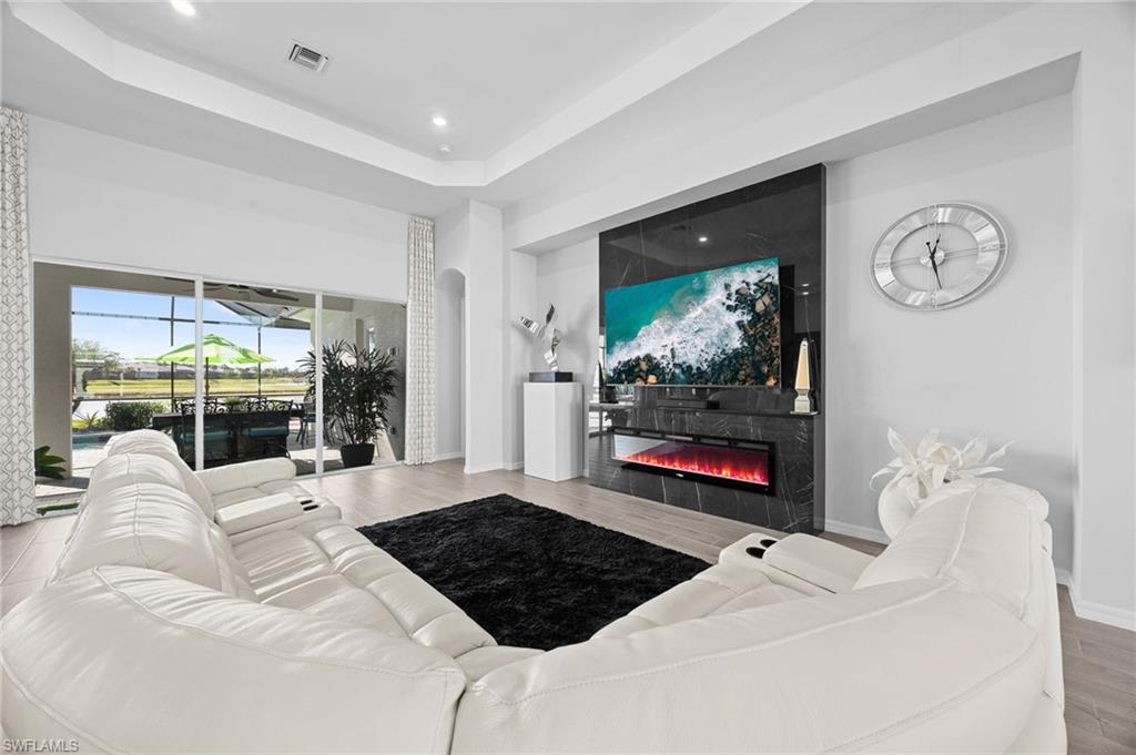 5415 Ternberry Road Ave Maria, FL 34142 - Photo 10 of 45 a living room with furniture fireplace and flat screen tv