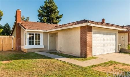 694 West Virginia Street Rialto, CA 92376 - Photo 1 of 1 a front view of a house with a yard