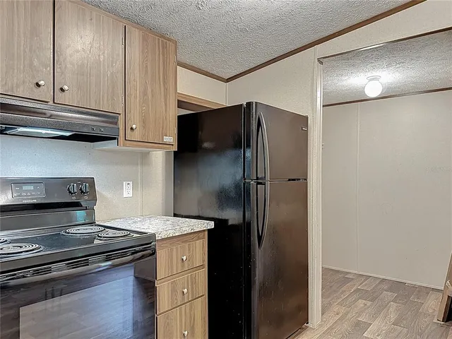 a kitchen with granite countertop a stove and a sink