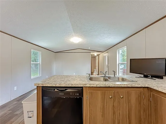 a kitchen with a sink stove and refrigerator