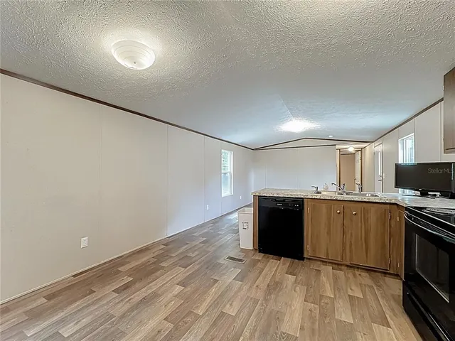 a kitchen with a refrigerator and a stove top oven