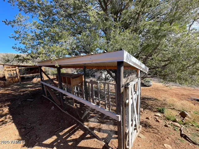 a view of a roof deck with wooden fence and a couple of chairs