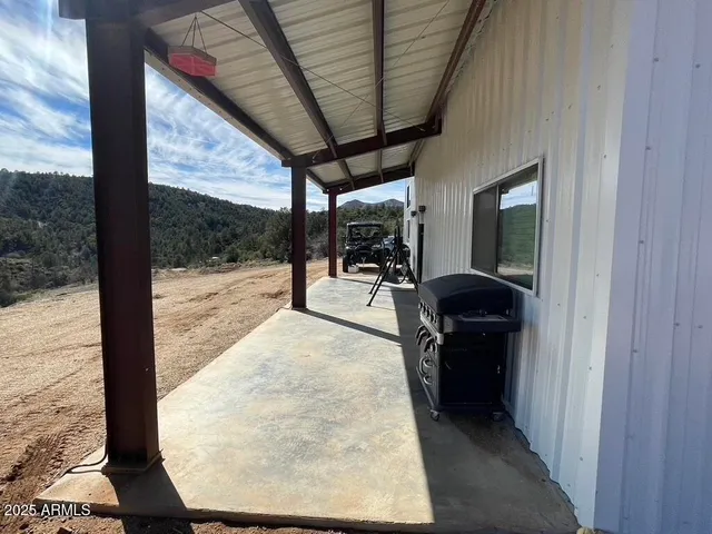 a living room with a large window and furniture