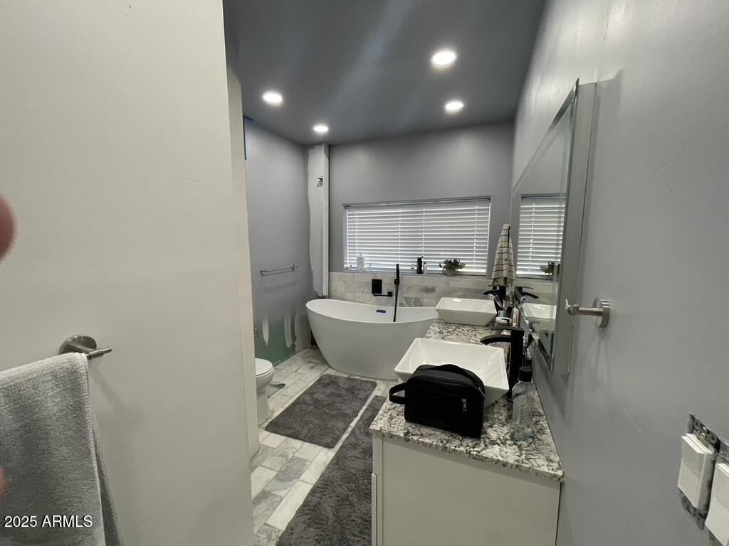 1076 East Horseshoe Springs Road Winkelman, AZ 85192 - Photo 22 of 31 a bathroom with a toilet sink and mirror