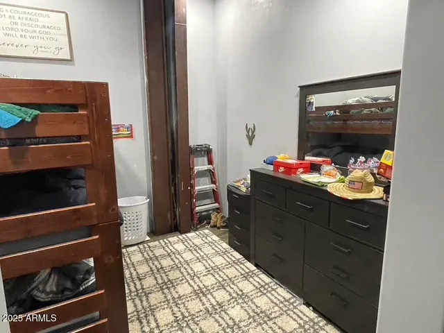 a bedroom with a bed and a dresser