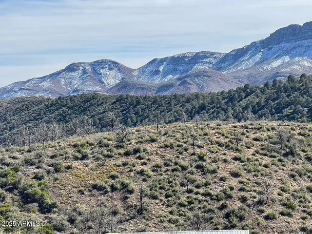 a view of a large mountain with a mountain in the background