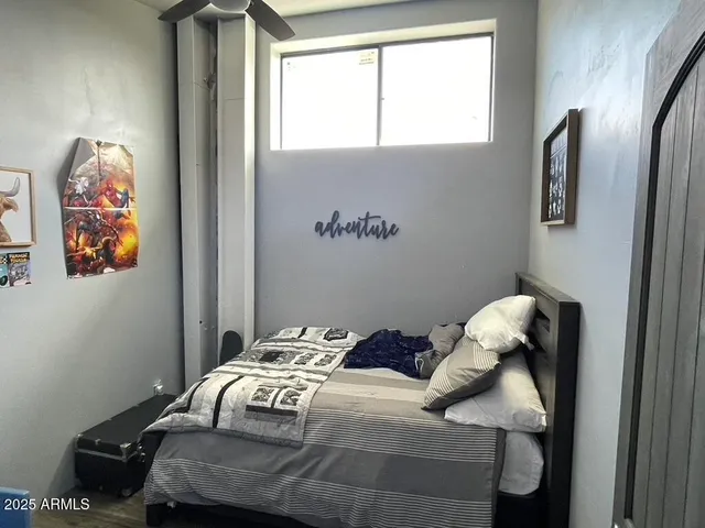 a bedroom with a bed and a window