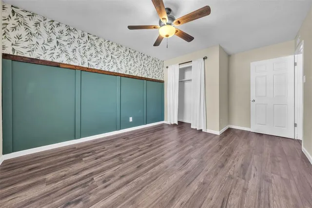 a view of a room with wooden floor