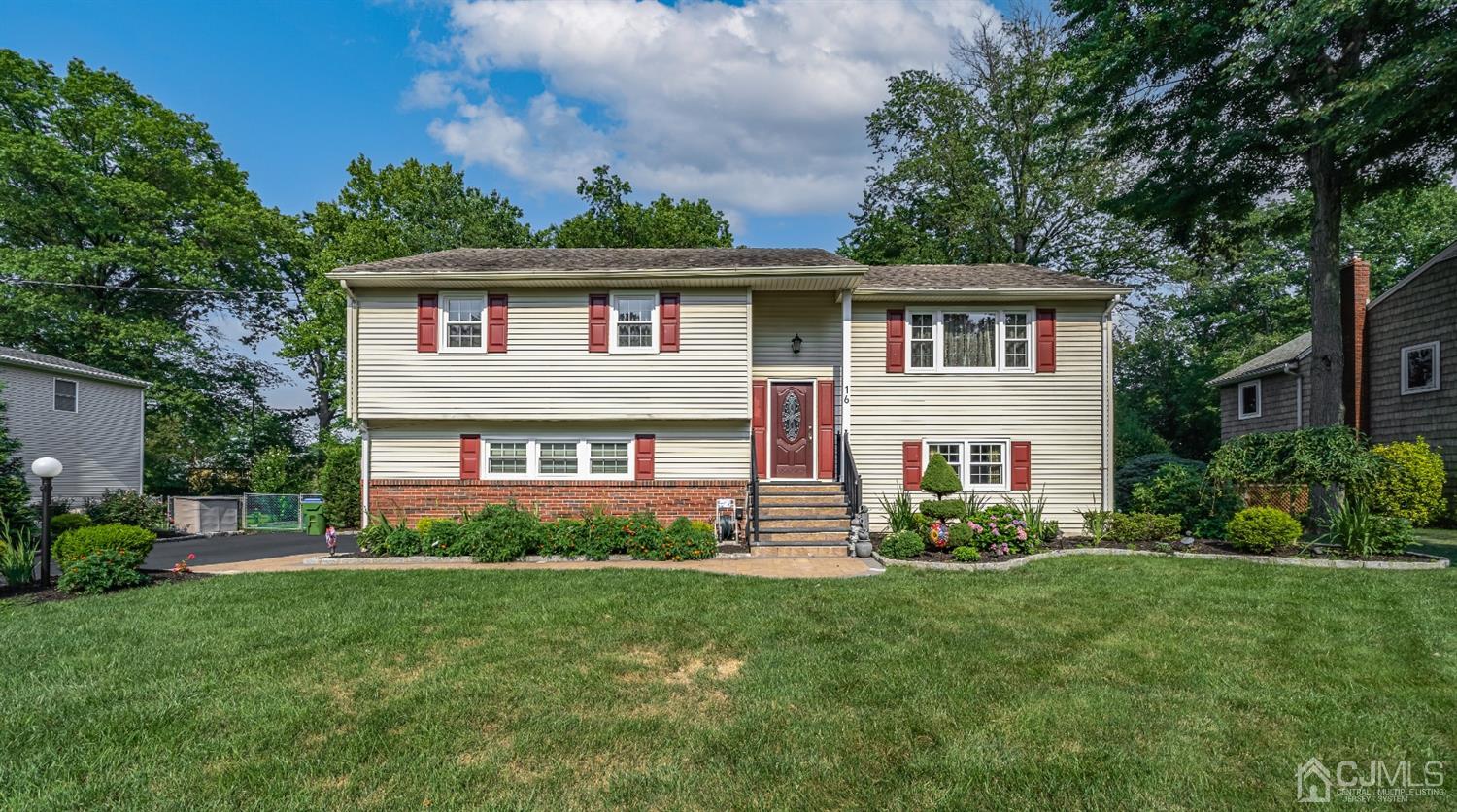 16 Hilltop Road Edison, NJ 08820 - Photo 1 of 30 a front view of a house with a garden and plants