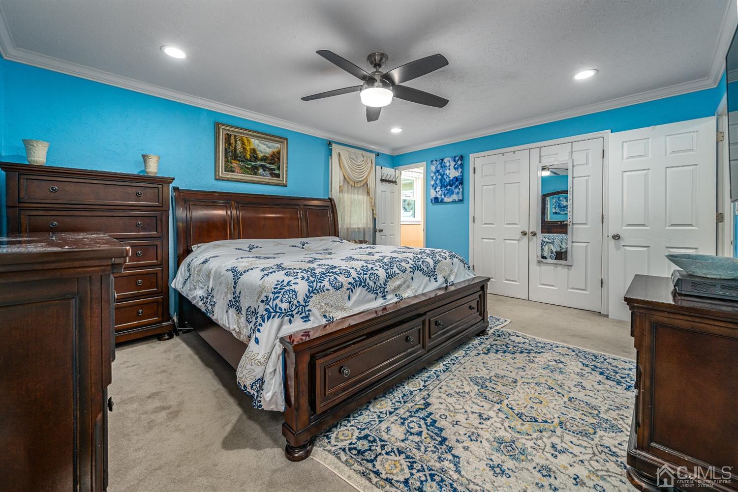 16 Hilltop Road Edison, NJ 08820 - Photo 16 of 30 a bedroom with a large bed and a chandelier