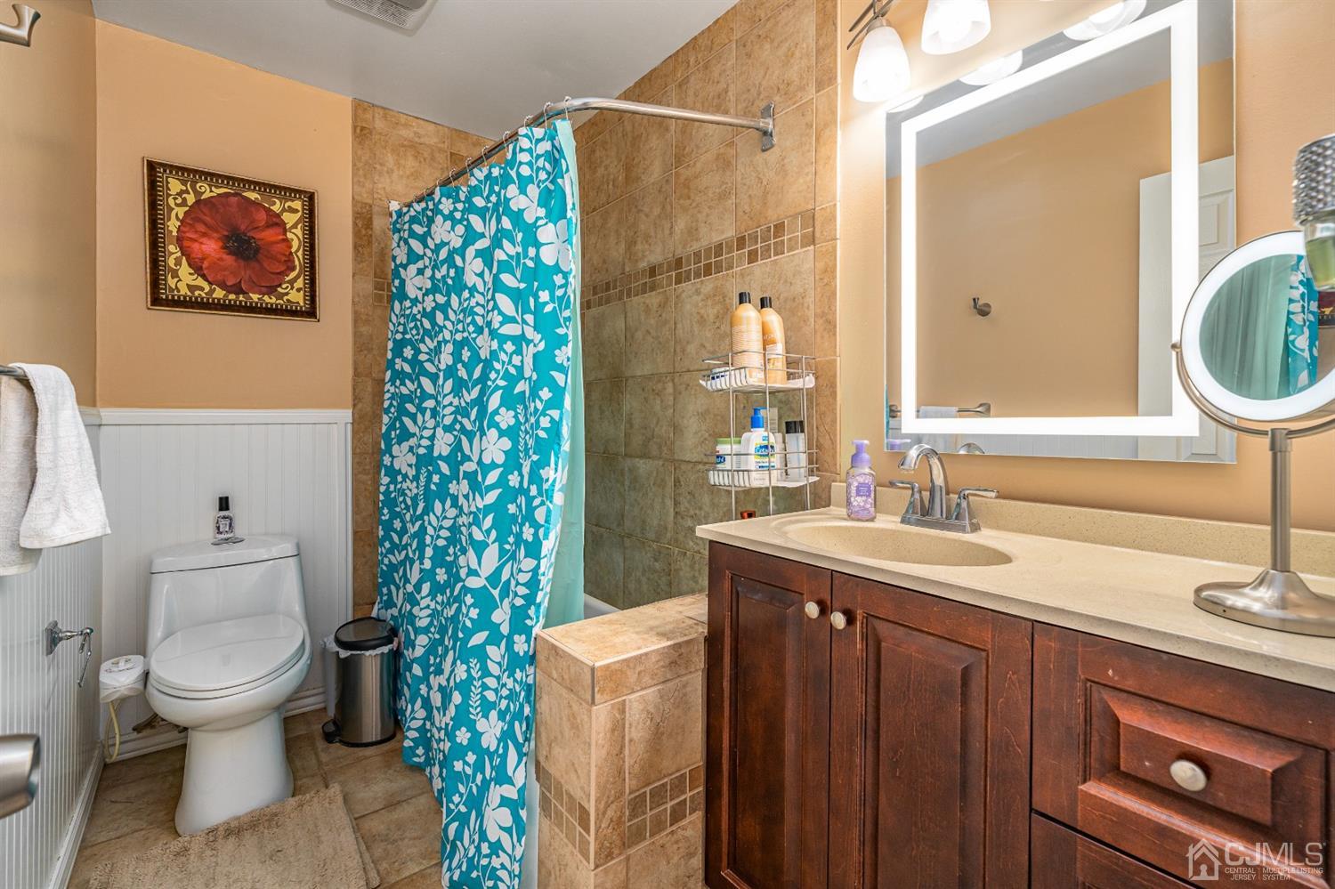 16 Hilltop Road Edison, NJ 08820 - Photo 18 of 30 a bathroom with a sink a toilet and a mirror
