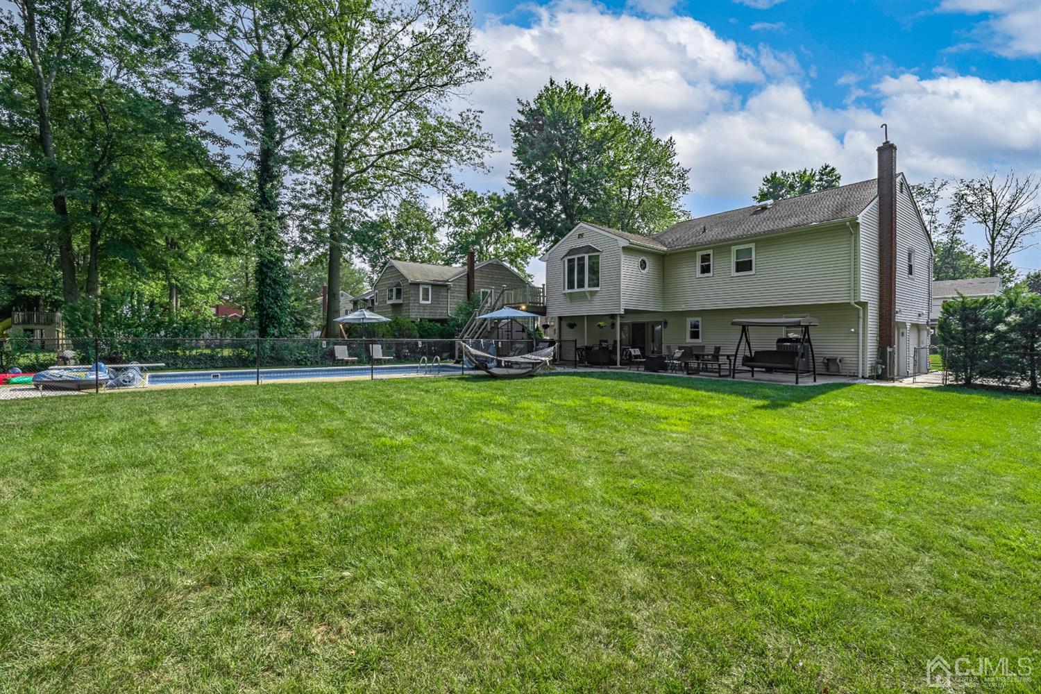 16 Hilltop Road Edison, NJ 08820 - Photo 25 of 30 a view of house in front of a big yard with large trees