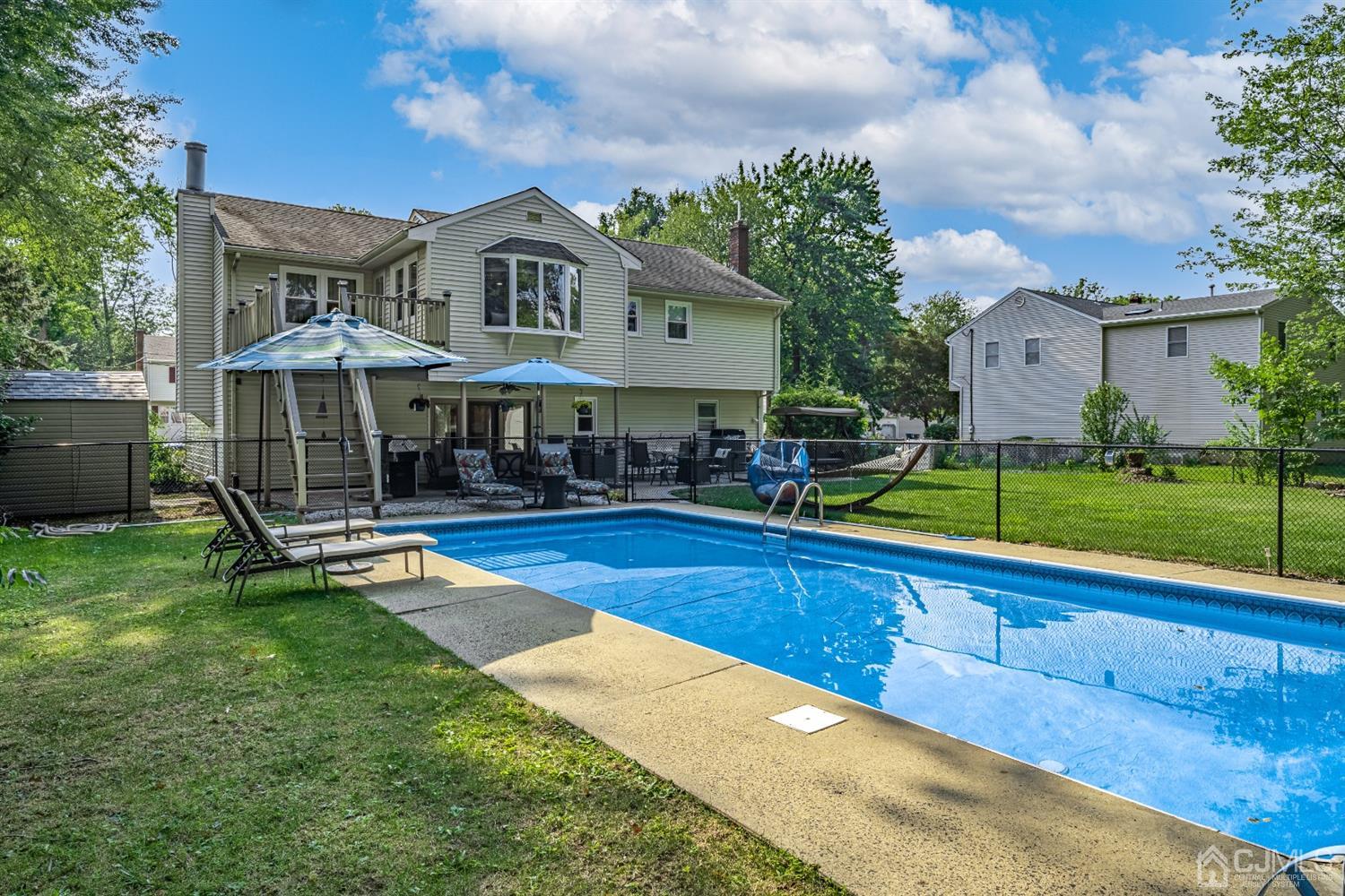 16 Hilltop Road Edison, NJ 08820 - Photo 27 of 30 a view of a house with a swimming pool and sitting area