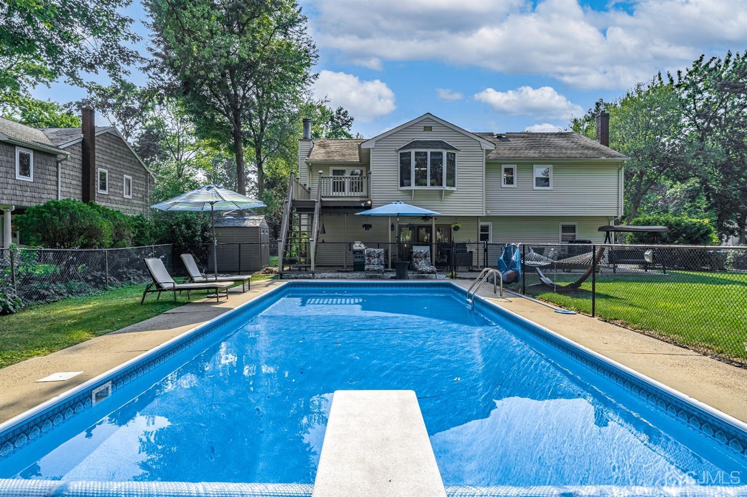 16 Hilltop Road Edison, NJ 08820 - Photo 28 of 30 a view of a house with swimming pool and sitting area