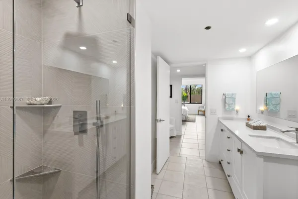 a bathroom with a double vanity sink toilet and shower
