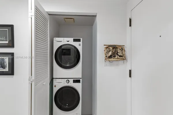 a view of a hallway with washer and dryer