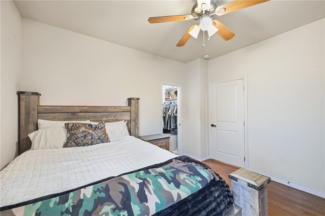 4400 Milam Street Bryan, TX 77801 - Photo 20 of 25 a bedroom with a bed and a chandelier