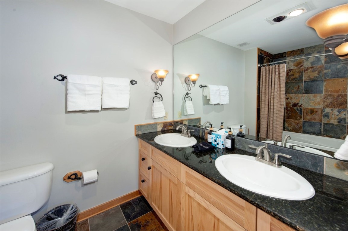 100 Dercum Square, Unit 8362 Keystone, CO 80435 - Photo 14 of 35 a bathroom with a granite countertop sink a mirror and a bathtub