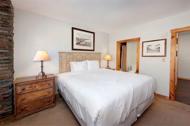 a bedroom with bed and painting on the wall