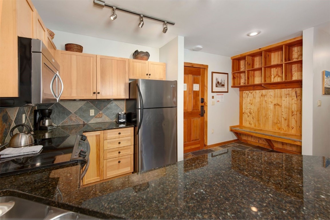 100 Dercum Square, Unit 8362 Keystone, CO 80435 - Photo 10 of 35 a kitchen with stainless steel appliances granite countertop a refrigerator and a stove top oven