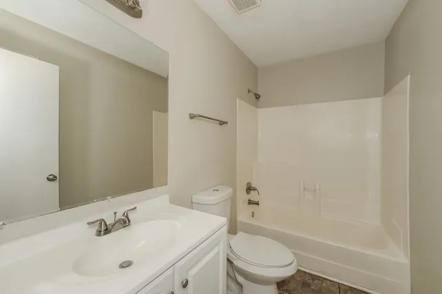 a view of a room with a ceiling fan