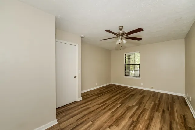 a kitchen with stainless steel appliances a refrigerator stove and white cabinets
