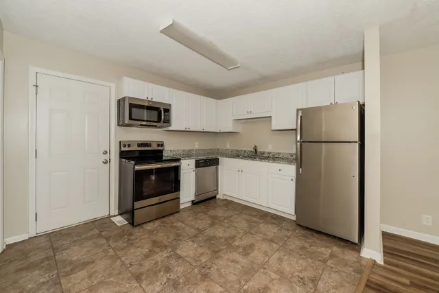 a kitchen with a refrigerator stove and a sink
