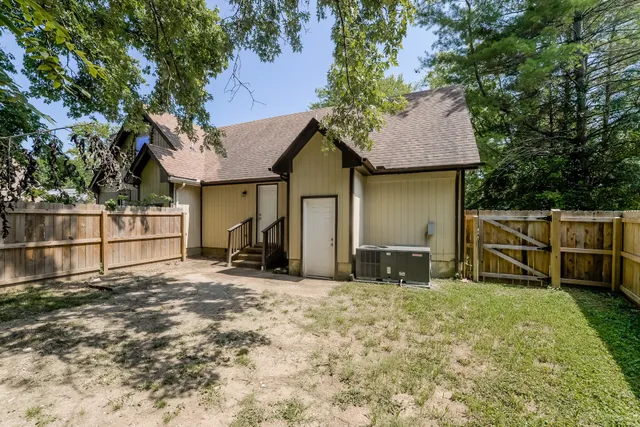 a view of a house with wooden fence