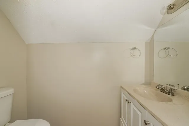 a bathroom with a sink toilet and vanity