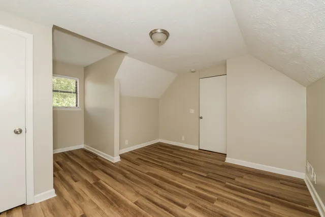 a view of room with wooden floor and closet