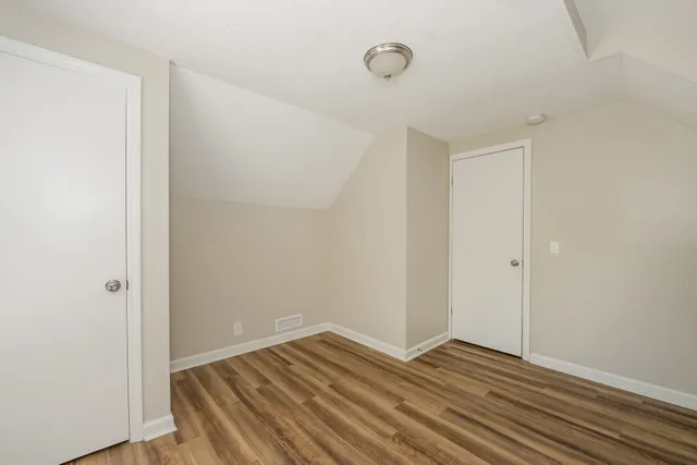 a view of wooden floor and windows in a room
