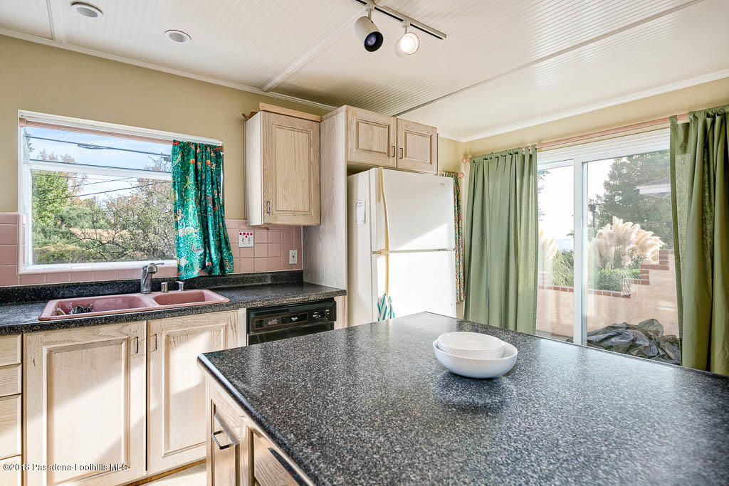 4329 El Prieto Road Altadena, CA 91001 - Photo 11 of 28 a kitchen with a stove a sink and a refrigerator