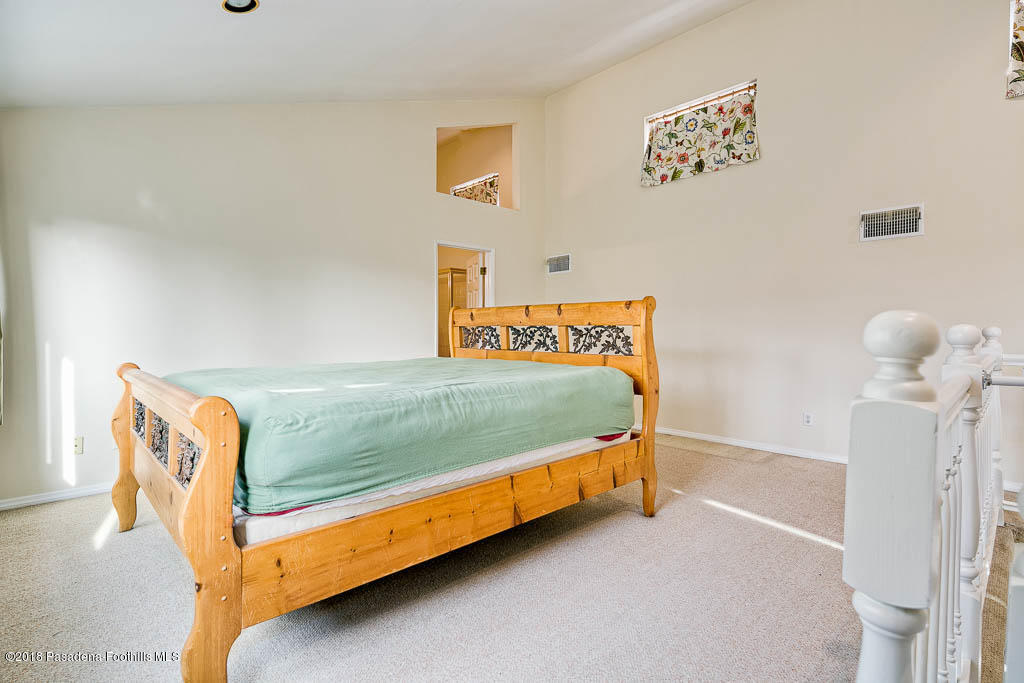 4329 El Prieto Road Altadena, CA 91001 - Photo 12 of 28 a bedroom with a bed and a painting on the wall